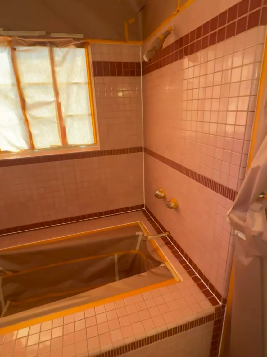 A bathroom masked off with paper and tape before spraying.