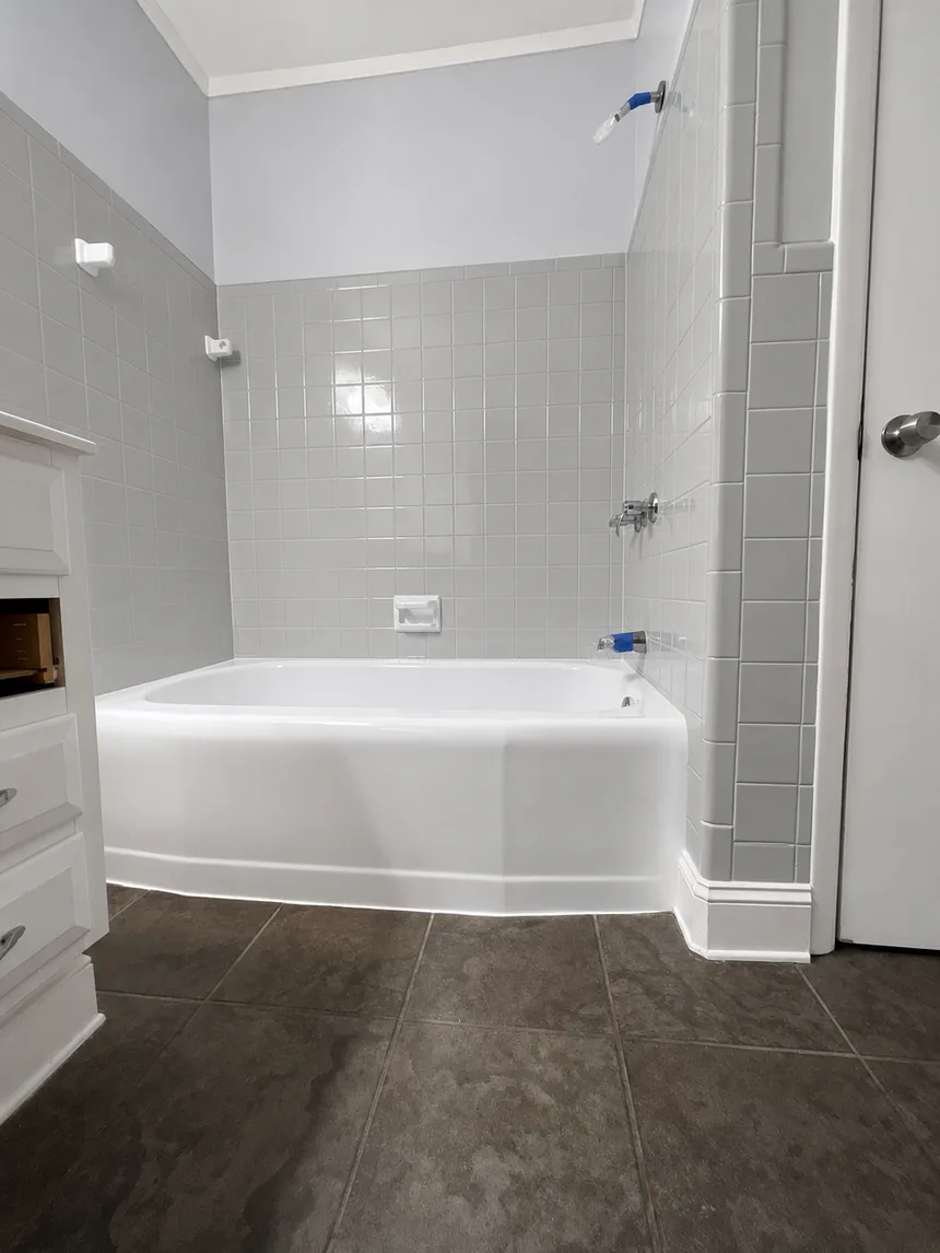 A refinished bathtub and white tile surround.